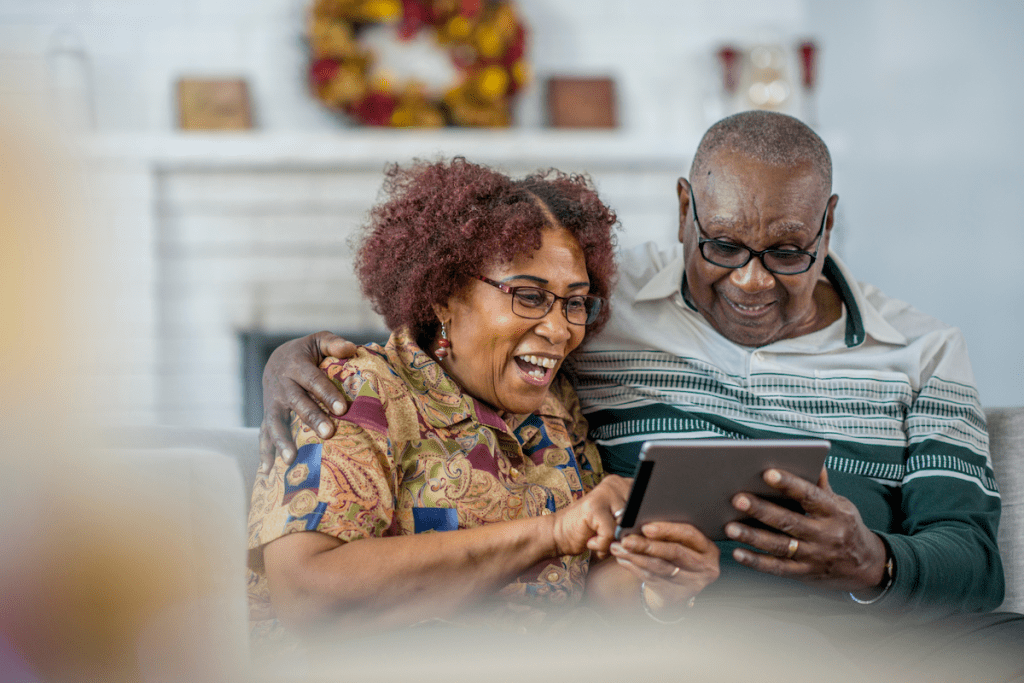 Two seniors look at a smart tablet